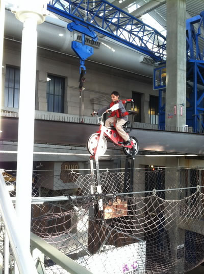 Picture of Nick riding the gravity bike at Science City